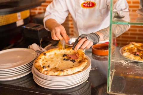 Artisan pizza oven. Chef preparing the pizza to sell it