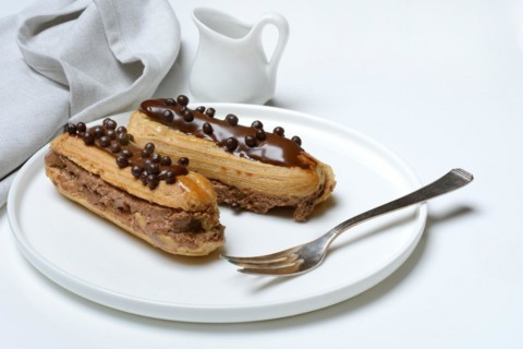 Two chocolate eclairs on a plate