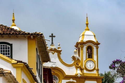 Facade of historic colonial style house and church in the famous city of Tiradentes in Minas Gerais