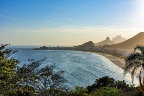 Copacabana beach and Rio de Janeiro mountains seen from above during summer sunset