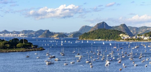 Panoramic image of Guanabara Bay with its boats and surrounded by the city of Rio de Janeiro with its hills during the afternoon