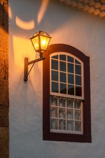 Old metal street lamp on the facade of a colonial-style house in the historic city of Tiradentes