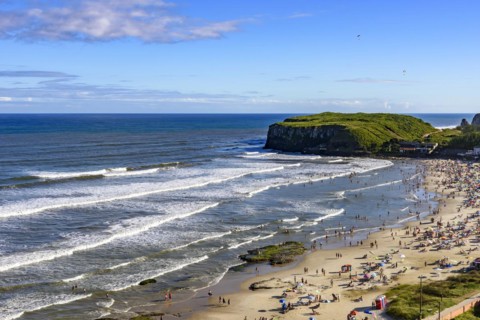 Beach on a beautiful sunny day in the summer of Torres city on the coast of Rio Grande do Sul state