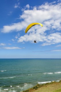 Paragliding flight over the sea from the city of Torres on the coast of the state of Rio Grande do Sul