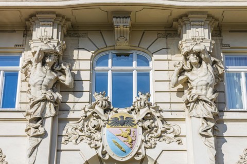 Stone figures as support on a historic facade