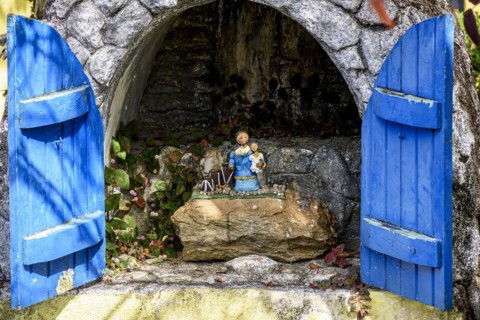 Small and simple altar with a figure of an Afro-American mother with her son and tribal drums honoring former slaves in the city of Lavras Novas in Minas Gerais