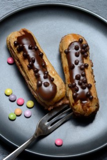 Two chocolate eclairs on a plate