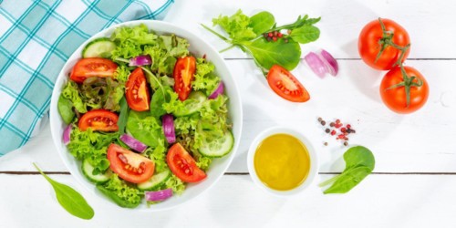 Mixed salad with fresh tomatoes healthy food eating from above banner on wooden board in Stuttgart