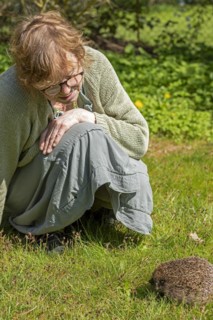 Woman looking at hedgehog