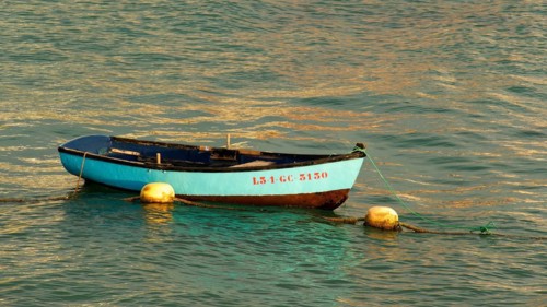 Turquoise small fishing boat