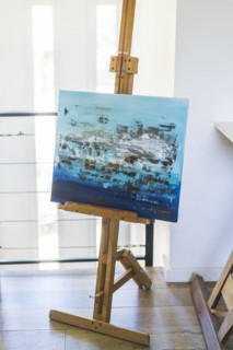 An artist easel with a painted canvas