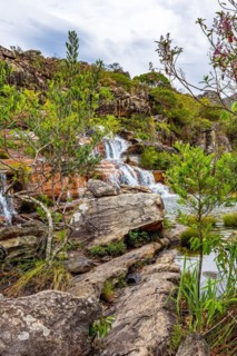 Set of clear water cascades among the rocks and native vegetation of the Biribiri environmental reserve in Diamantina