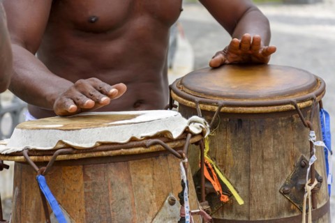 Musician playing atabaque which is a percussion instrument of African origin used in samba