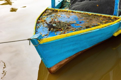 Rustic wooden fishing boat over the waters of the Paraty channel
