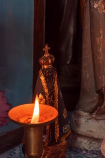 Image of our lady appeared on an altar lit by a candle during religious worship in the interior of Brazil