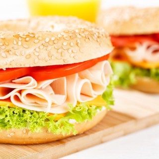 Bagel sandwich for breakfast topped with chicken ham close-up square in Stuttgart