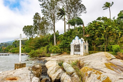 Small and old chapel on the rocks by the sea in Ilhabela island on the north coast of Sao Paulo