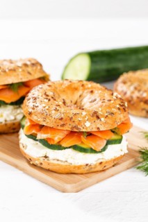 Bagel sandwich for breakfast topped with salmon fish on a board in Stuttgart