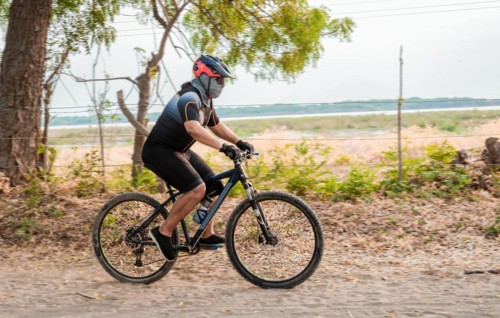Lifestyle of a chubby cyclist on the road. Professional cyclist on a dirt road