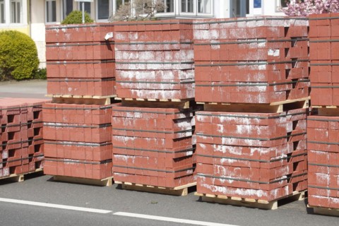 Stacked red building blocks on a construction site for a bicycle path