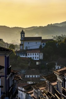 Old church seen in the city of Ouro Preto during sunset with its houses in colonial architecture