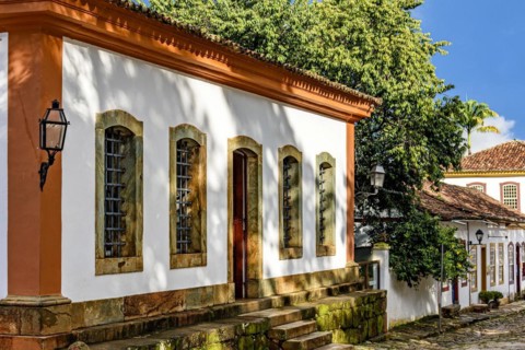 Facade of old colorful colonial houses on a cobbled street in the historic city of Tiradentes in Minas Gerais