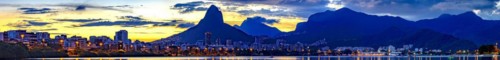 Panoramic image of summer sunset seen from the lagoon Rodrigo de Freitas with the buildings of the city of Rio de Janeiro
