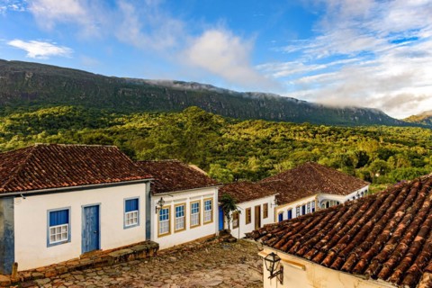 View of the old historic city of Tiradentes with its historic colonial-style houses and mountains in the background during the afternoon in Minas Gerais