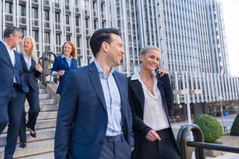 Senior Executives Exchange Ideas While Descending Stairs in Business District