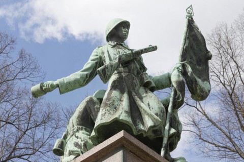 Soviet soldier with weapon and flag
