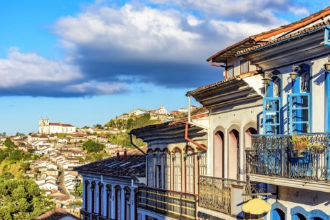 Old colonial style houses and baroque church lit by the afternoon sun in the historic town of Ouro Preto in Minas Gerais