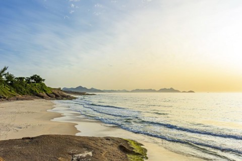 The small Devil beach located between Copacabana and Ipanema in Rio de Janeiro at dawn with the mountains in the background