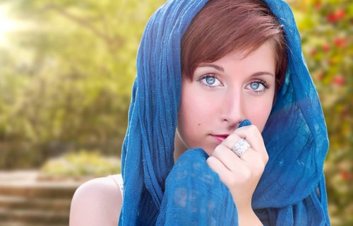 Pretty blue eyed young red haired adult female outdoor portrait