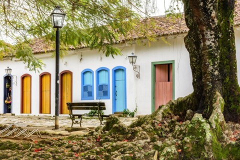 Streets of cobblestone and old houses in colonial style behind the tree on the streets of the old and historic city of Paraty founded in the 17th century on the coast of the state of Rio de Janeiro