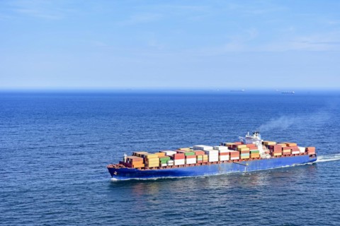 Cargo ship carrying several containers on the waters of the blue sea of rio de Janeiro