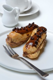 Two chocolate eclairs on a plate