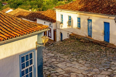 Cobbled street and colorful colonial-style houses in the afternoon on the old and historic city of Tiradentes in Minas Gerais