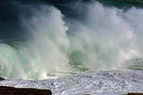Wave crashing against rocks during storm day at Ipanema beach