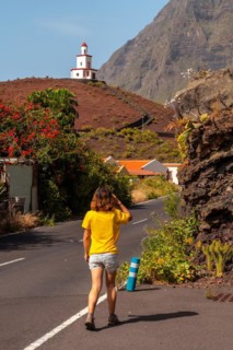 Woman tourist visiting the Joapira bell tower above the parish church of Nuestra Senora de Candelaria in La Frontera on El Hierro