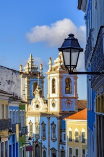 Colorful colonial houses facades and historic church towers in baroque and colonial style with blue sky in the famous Pelourinho district of Salvador