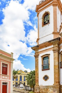 Old cobblestone street with houses and church in colonial architecture in the famous city of Ouro Preto in Minas Gerais