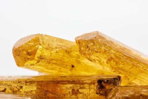 Studio photography of some Brazilian imperial topaz in raw state with white background