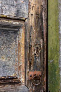 Detail of antique wooden door and lock deteriorated by time and rust in a colonial style house in the historic city of Diamantina in Minas Gerais