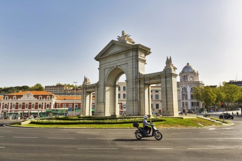 Monumental gate Puerta de San Vicente in a roundabout