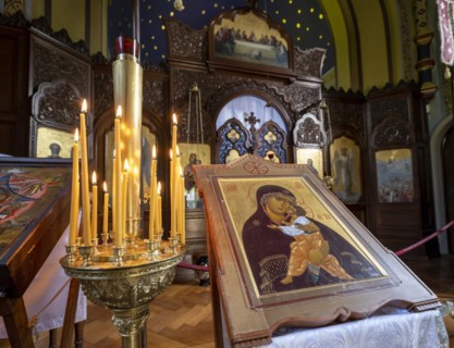 Burning candles next to an icon in the Russian Chapel