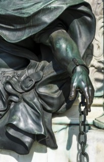 Detail photo of the chained warriors at the base of the equestrian statue of Frederick William of Brandenburg