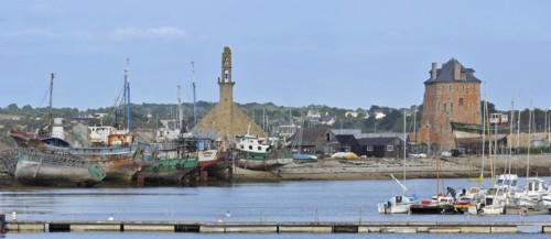 The fortification Tour Vauban and wrecks of small trawler fishing boats in the harbour of Camaret-sur-Mer