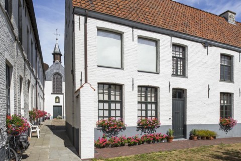 Alley with white beguines' houses and chapel in the Beguinage of Oudenaarde