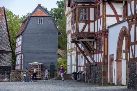 People in a street with historic half-timbered houses