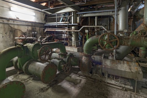 Water pipes in a machine room of a former paper factory